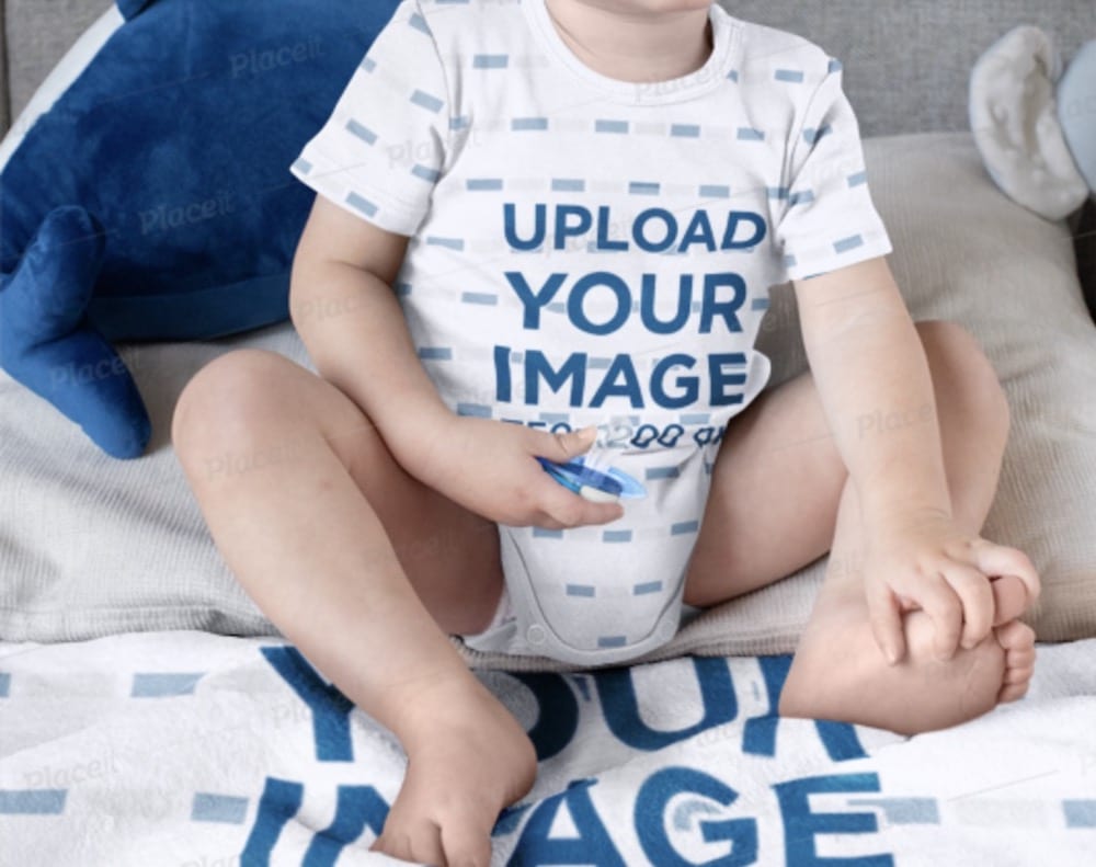 boy in onesie sitting on a blanket mockup