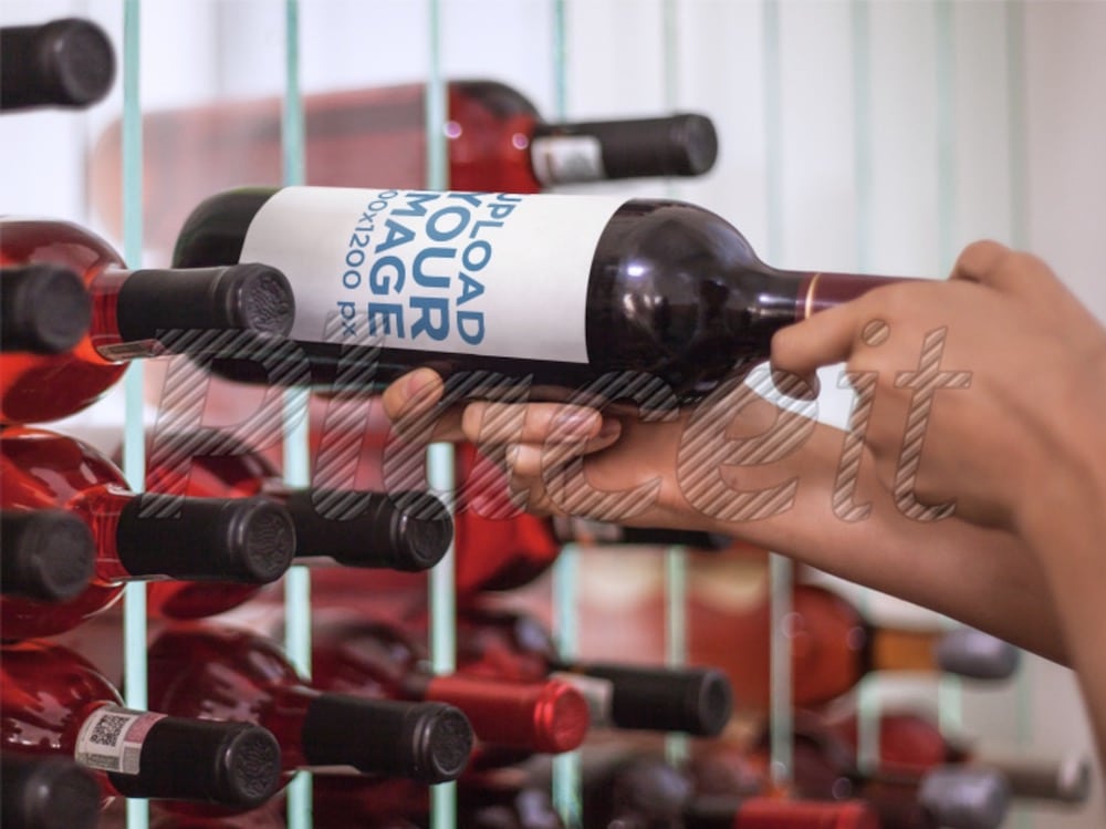 man picking up a wine bottle from a wine cellar mockup