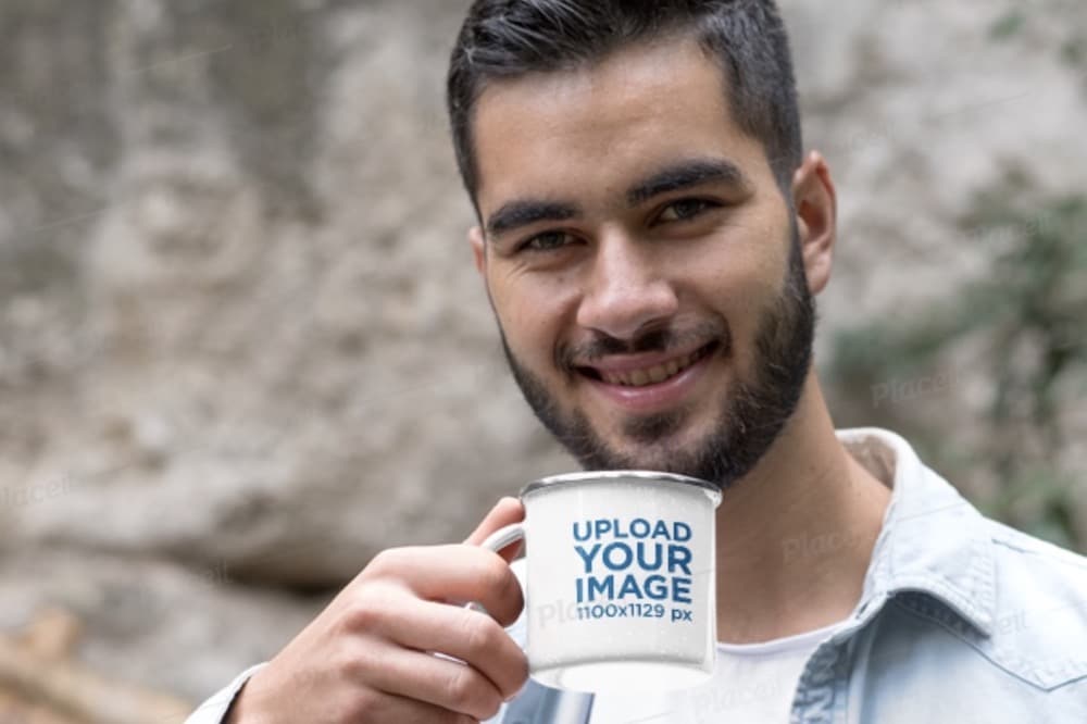 man drinking coffee from a enamel mug