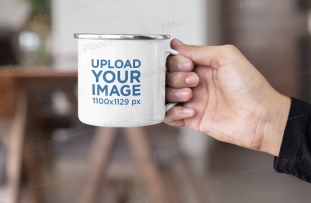 mockup of a hand holding an enamel mug