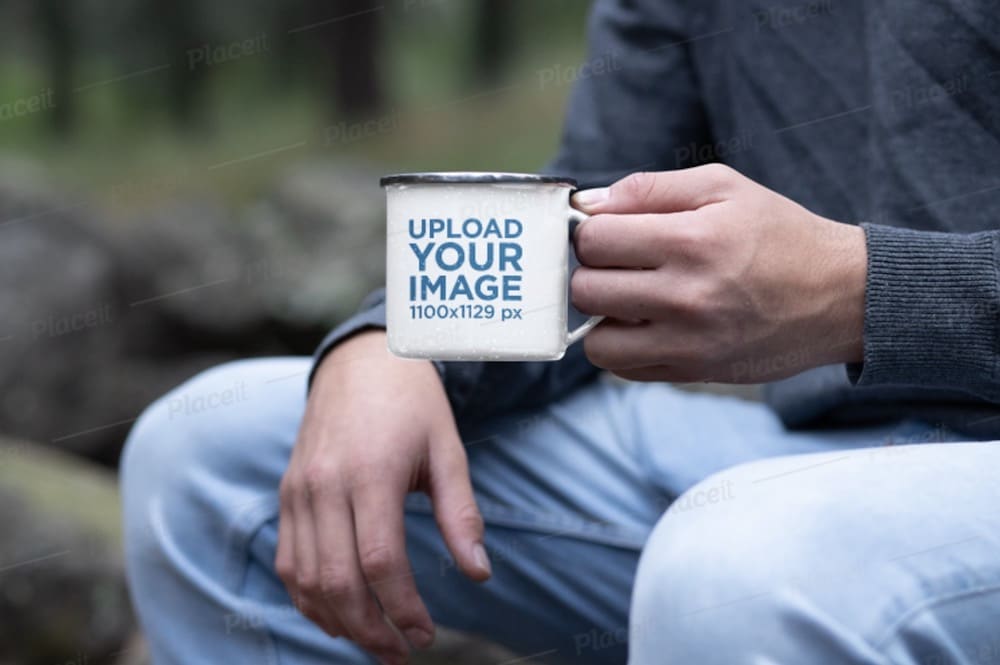 mockup of a man holding a 12 oz silver rim enamel mug