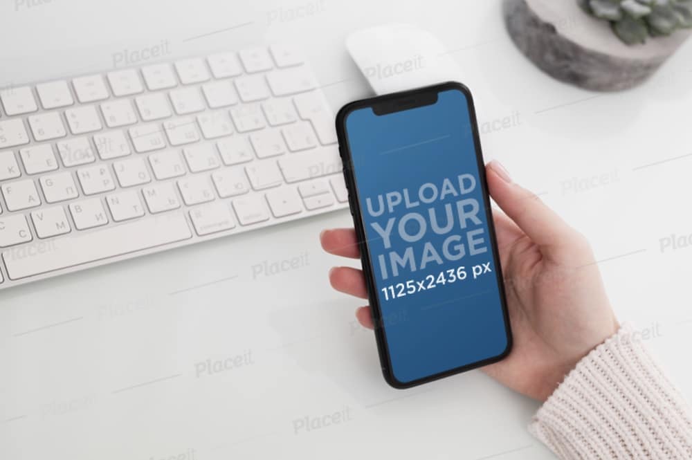 woman's hand holding an iphone