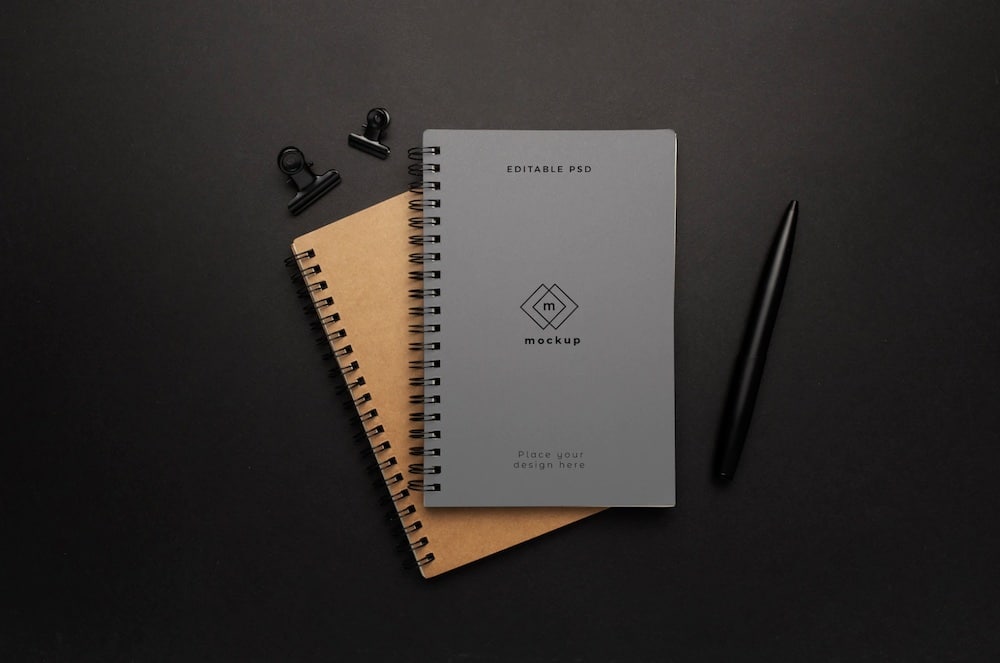 elegant notepad on black surface mockup