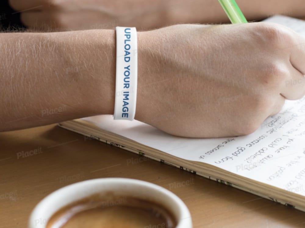 man wearing a wristband while writing mockup