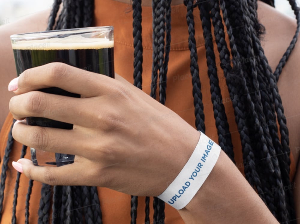 paper wristband mockup of a woman holding a beer