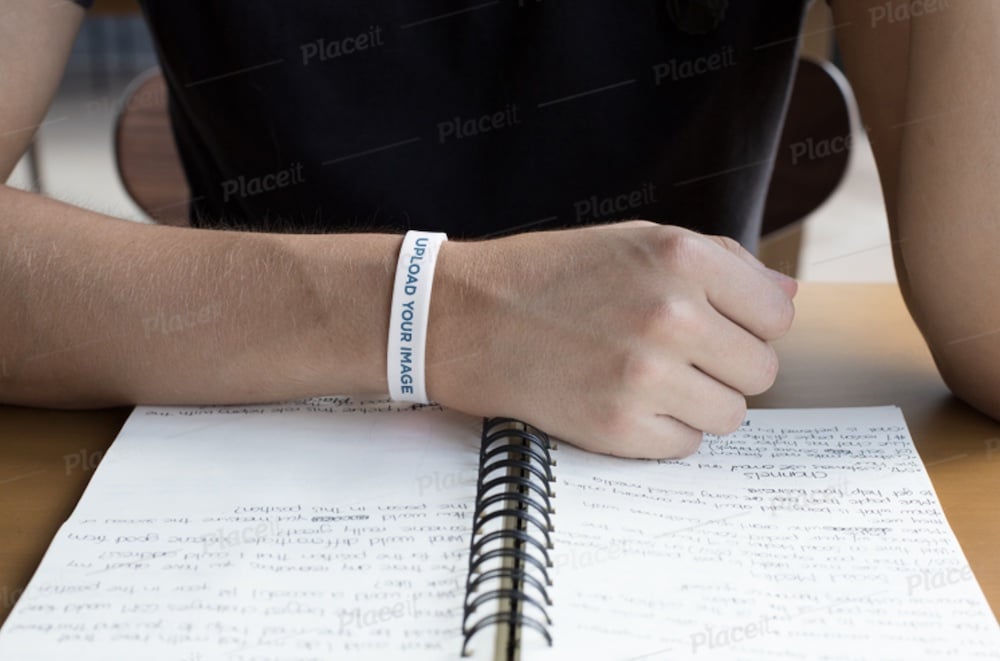 rubber bracelet mockup of a man looking at his notes